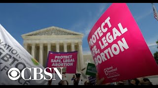 Federal judge blocks Texas abortion law, calls it "unconstitutional"