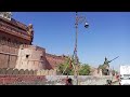 "Nat Kartab-The Art"An artist is balancing on a single rope with stick in hand and pots on her head.