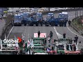 Farmer protests armoured police vehicles block highway as tractors push to reach paris