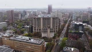 Gray foggy morning over University of Toronto Robarts Library, traffic moving along St. George