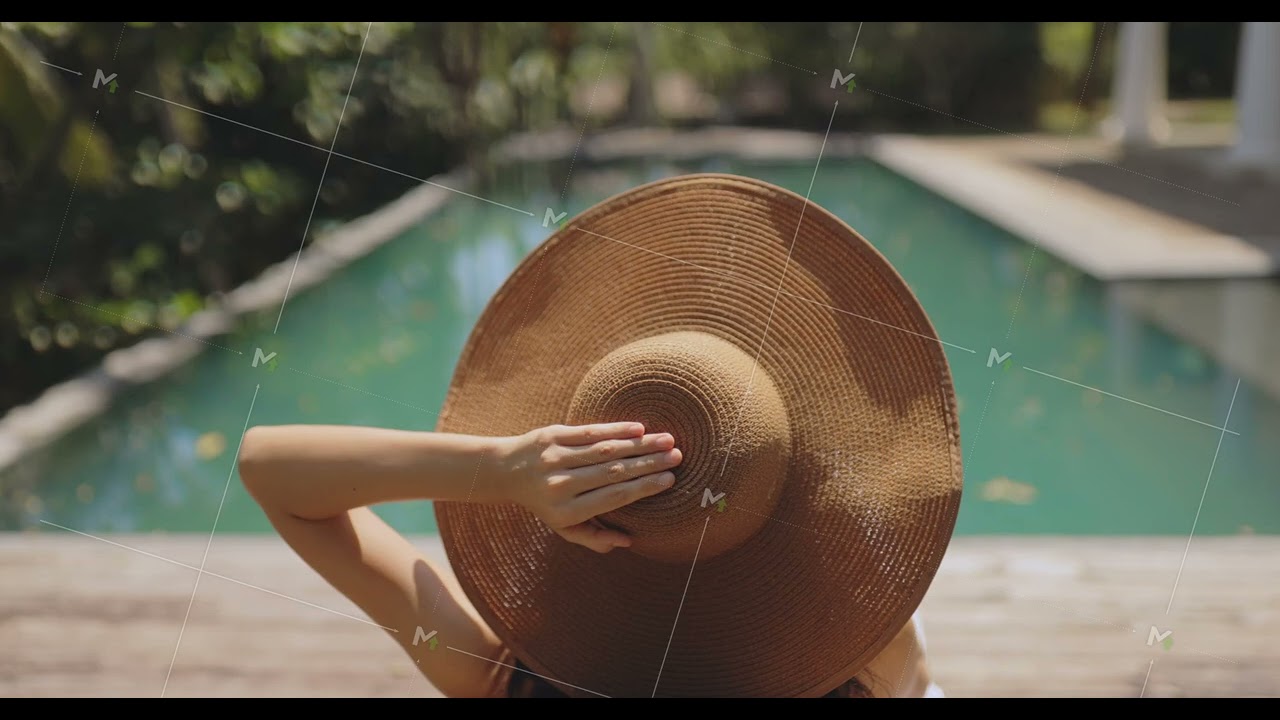 Woman Lounging by Pool With Sun Hat and Refreshing Beverage