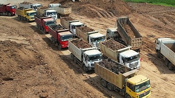 Dump Truck Traffic Jam Waiting Unloading Wet Soil At Work - Bulldozer Pushing Building Big Project