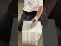 a special material that is being carved using tools provided by a worker