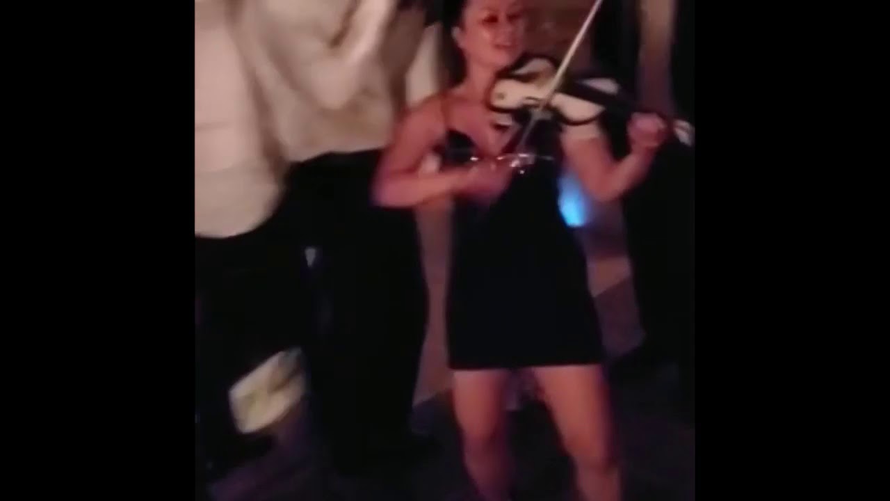 Yennie performing an electric violin and DJ combo