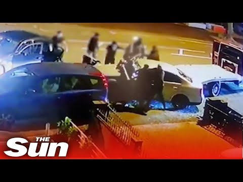 Massive gang of thugs smash up car with baseball bats in Birmingham.