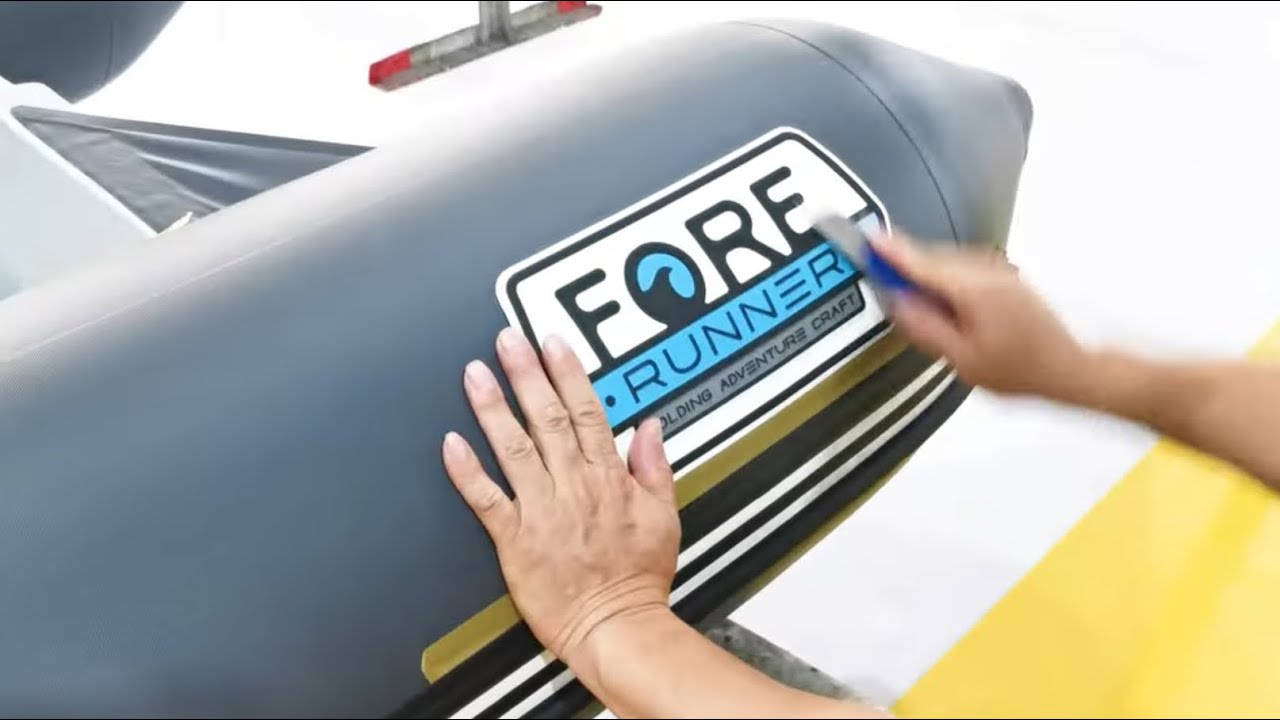 People in a clean factory assemble materials to make a Folding Rib Fore Runner boat.