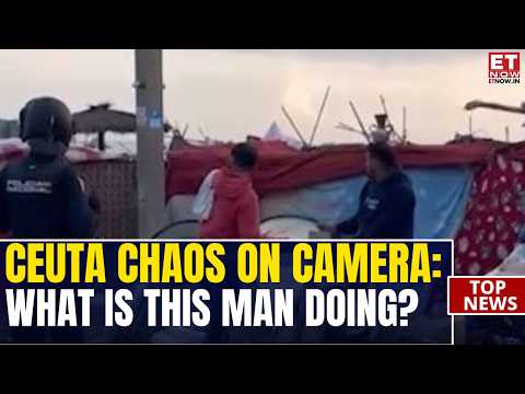 CEUTA CAMP CLEARED: Police Move In as Man Pedals Through Dramatic Migrant Scene | VIRAL VIDEO