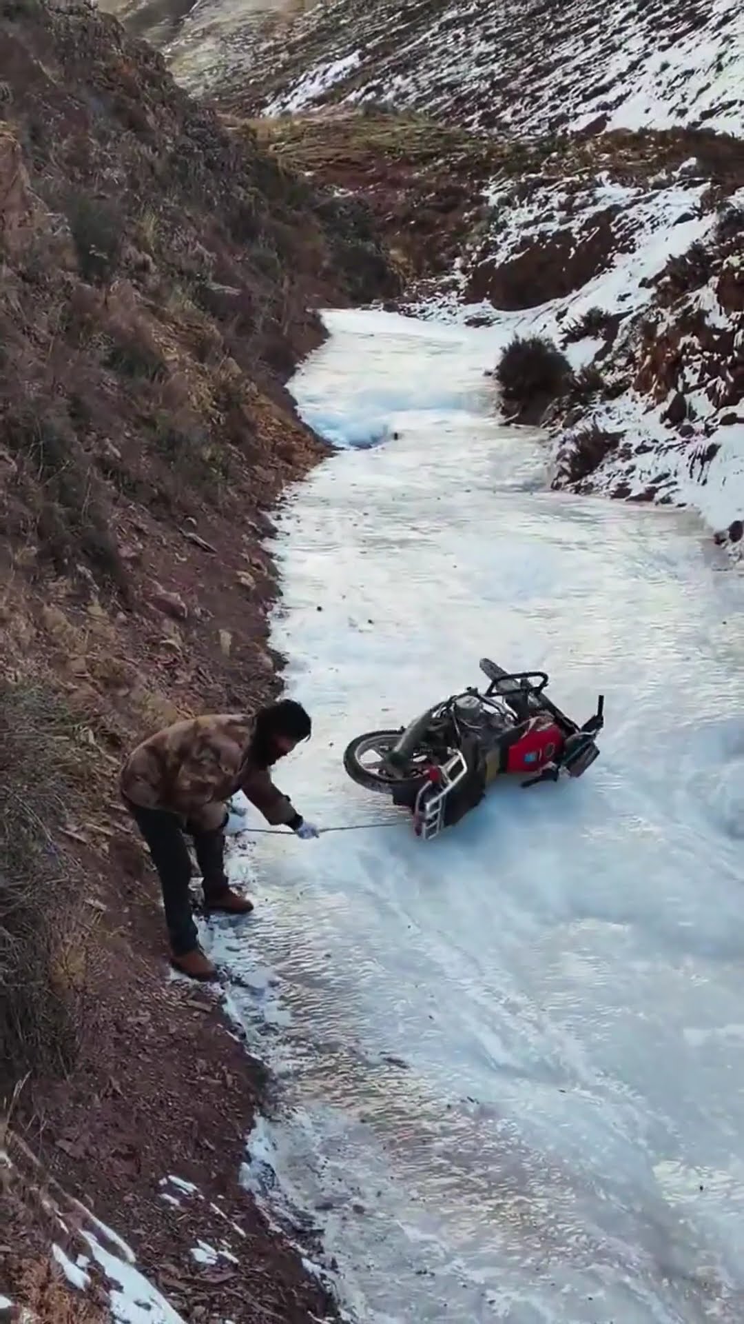 Pulling a motorcycle out of gas off the ice