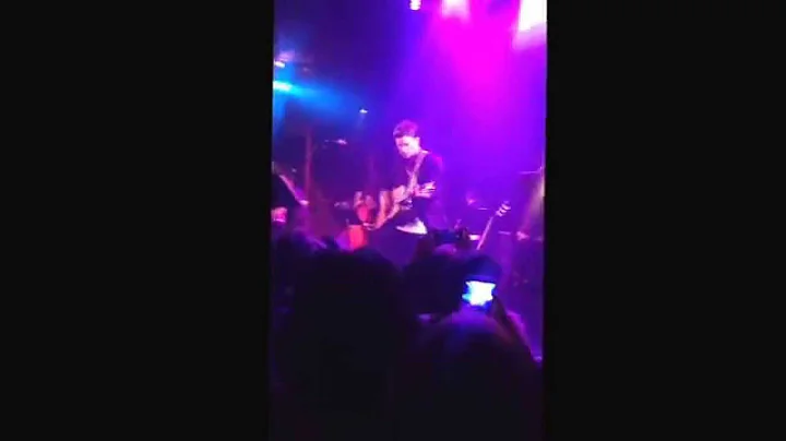 Jamie Scott dancing around with his guitar