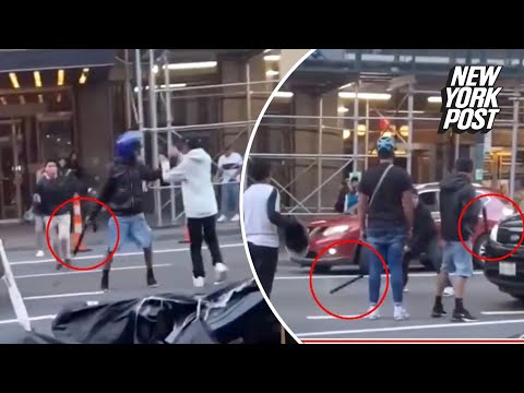 Migrants swing bats, belts and even traffic cones at each other in wild brawl outside NYC hotel