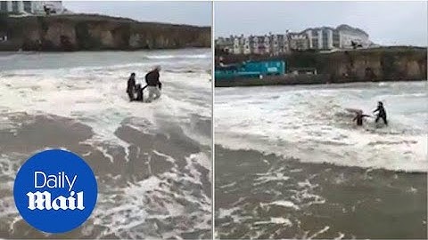 Heart-stopping moment girl on a beach is swept away by the tide - Daily Mail