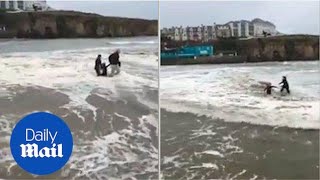 Heart-stopping moment girl on a beach is swept away by the tide - Daily Mail