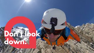 Base jumper leaps from the top of the peak of mountain | SWNS