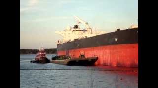 Cargo ship, barge, and tug boat at work