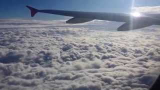 Airplane taking off & ascending above the clouds