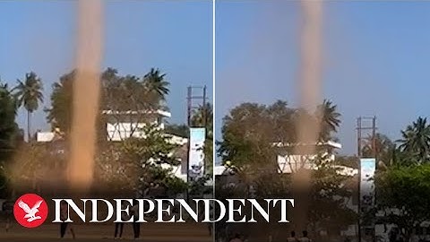 Towering whirlwind spins across field as witnesses look on in amazement