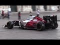 Valtteri bottas driving a sauber c32 through the streets of milan