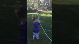 Boy Plays with His Hose-Loving Puppy