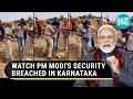 Modis security breached in karnataka man runs towards pms convoy in davanagere