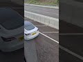 A white Tesla was driving on a Hong Kong Highway