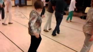 Seniors take a country line dancing class at the Chilson Senior Center.