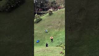 Boy Slides on Plastic Barrel, Flips Over, and Falls Down Hill as Girl Runs to Help