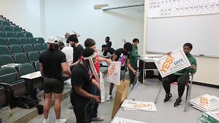 Rocky Mountain College Football players volunteer to assemble Yes for Safe Schools yard signs