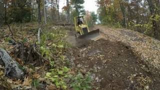 Bulldozer grading driveway hill