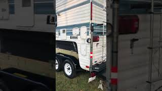 Truck Camper, mounted on a car trailer.