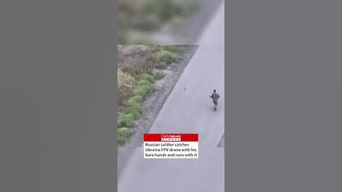 Russian soldier catches Ukraine FPV drone with his bare hands and runs with it