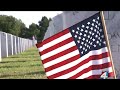 Thousands of volunteers show up to place flags for Memorial Day at Jacksonville National Cemetery