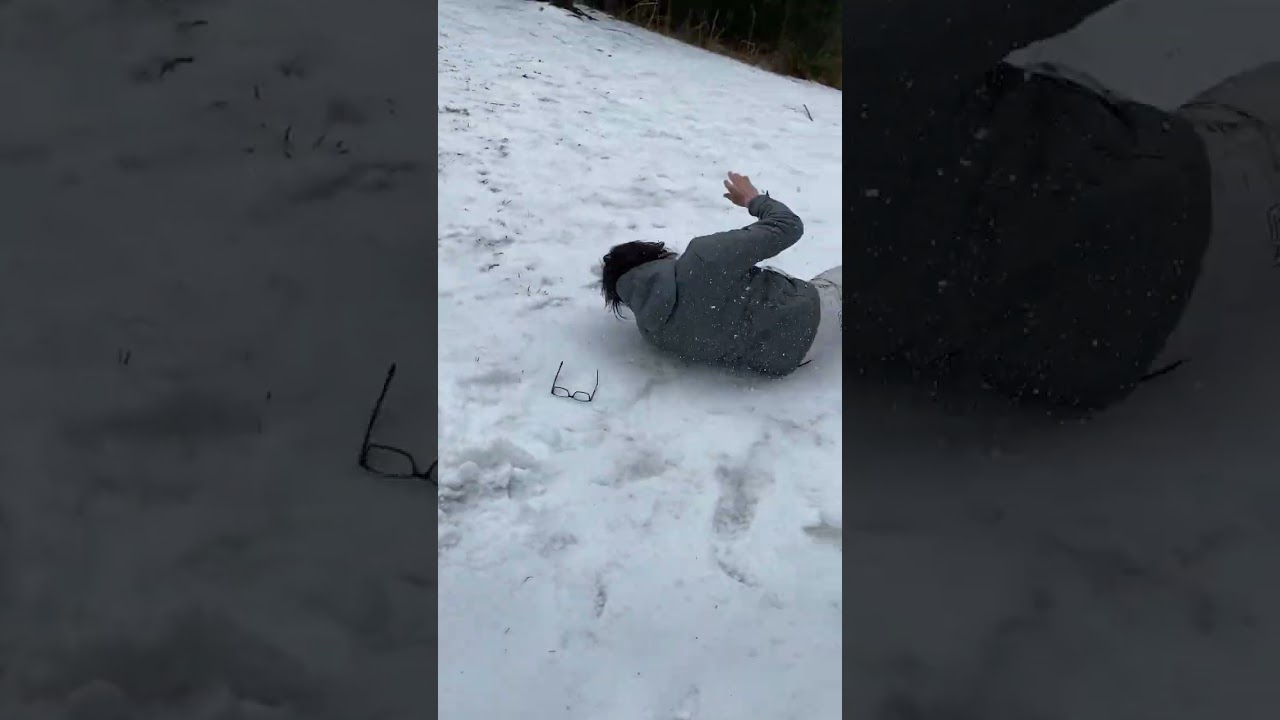 Guy rides sled down snow hill and faceplants into scorpion position