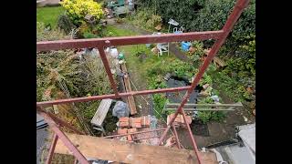 timber frame job, lime render panel, top of scaffold, garden view