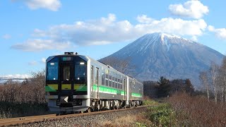 【山線】H１００形《DECMO》と頂上が冠雪した羊蹄山