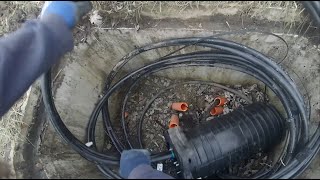 Underground fiber optic internet installation with stone driveway dig and bury