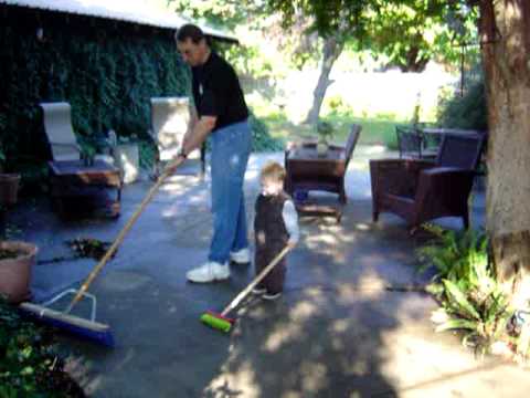 Poppa teaches Conner to use the push broom.