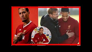 Virgil van Dijk poses in a Liverpool shirt for the first time