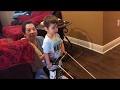 Jaxon two years old in his front gait trainer/walker testing toddler cane fit