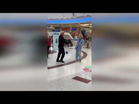 Heartwarming moment elderly Scots couple dance to Christmas carols in Glasgow shopping centre