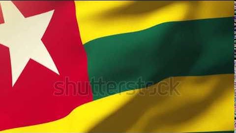 Togo flag waving in the wind. Looping sun rises style. Animation loop Stock video by