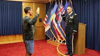 A new Soldier takes oath of enlistment administered by his father on behalf of the DoD.