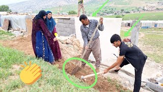 Family cooperation: filling the pit behind the house by Hossein and his son\