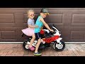 Little girl elis ride on bmw motorbike with thomas outdoor activity