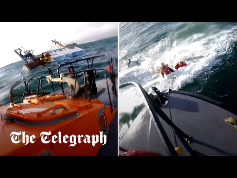Crew members jump off sinking ship and swim for their lives in dramatic rescue video