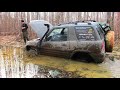 Two upgraded RAV4 on muddy roads in the spring forest