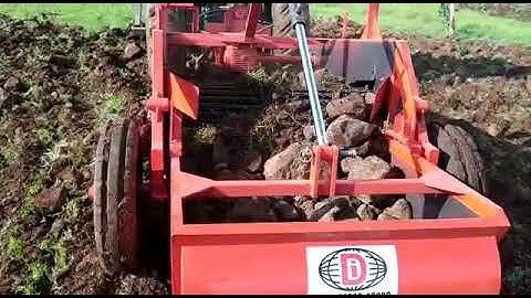 Big stones in stone picker machine ROCK KING.