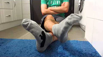 Young guy showing his feet and socks