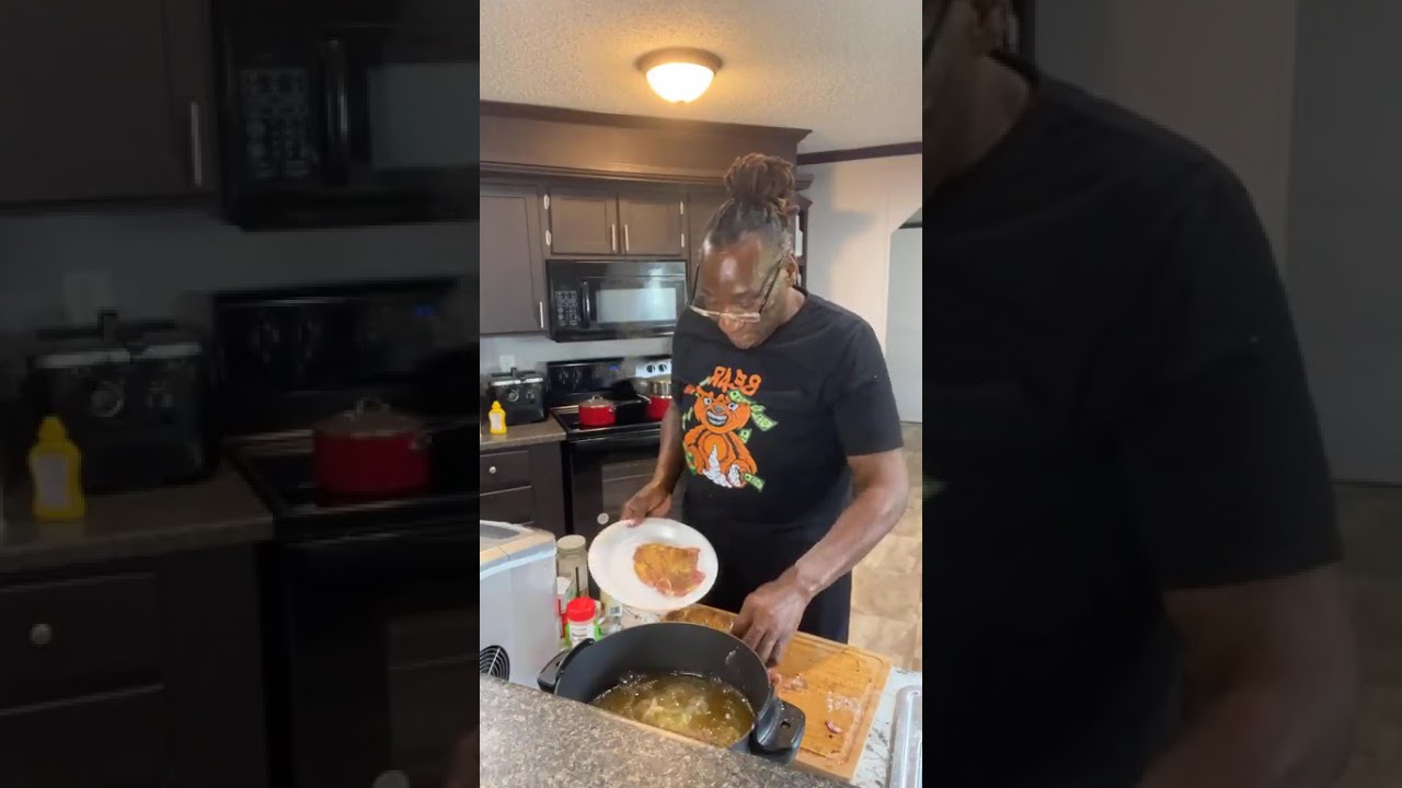 Mrs Netta is cooking fried pork chops, Asparagus and Mashed Potatoes for Charles dinner