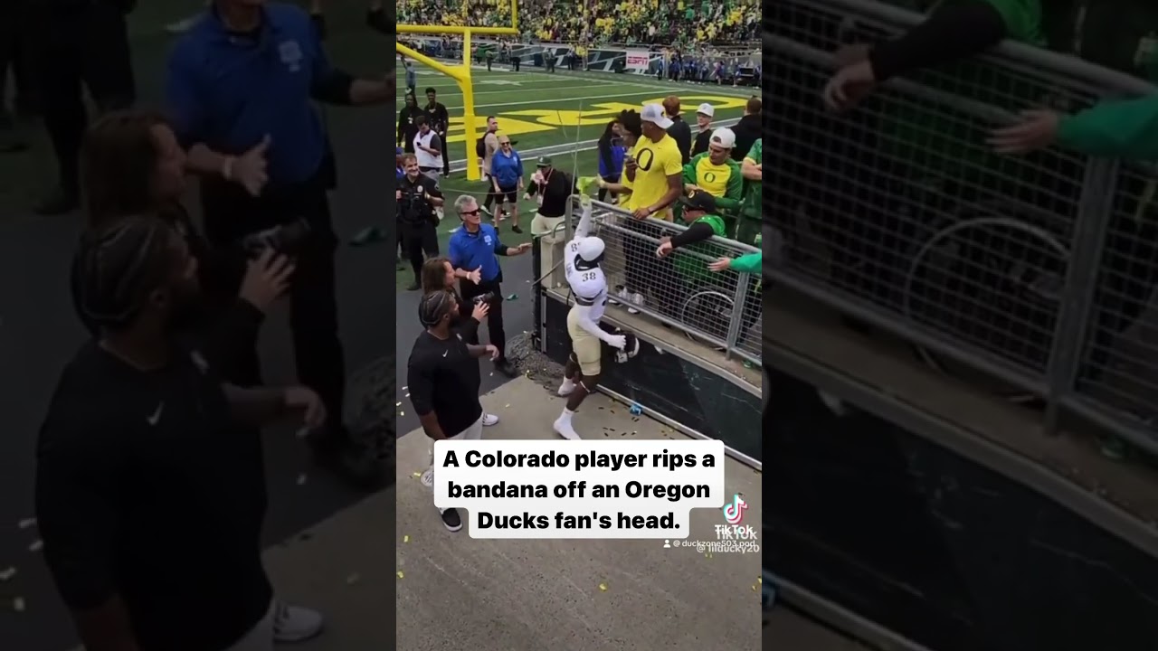 A Colorado player rips a bandana off an Oregon Ducks fan’s head.