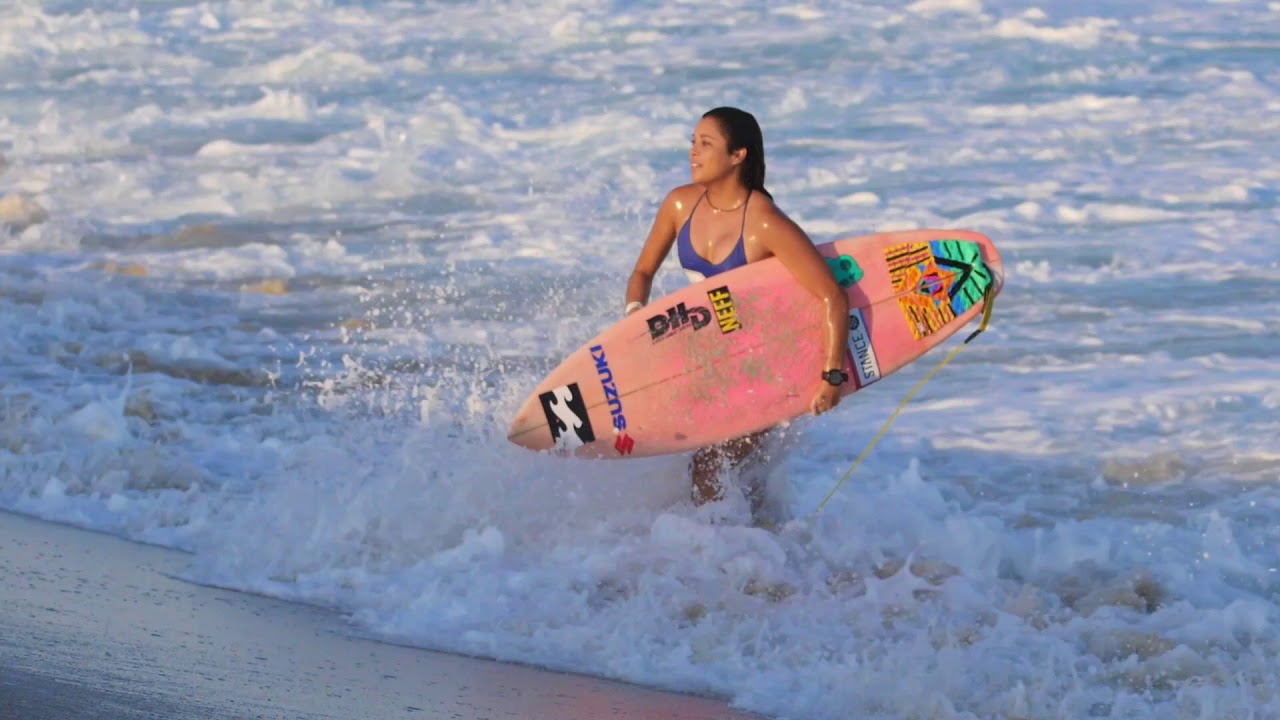 Kook of the day  girl pink surfboard blue bikini running out of water from wave gets knocked over